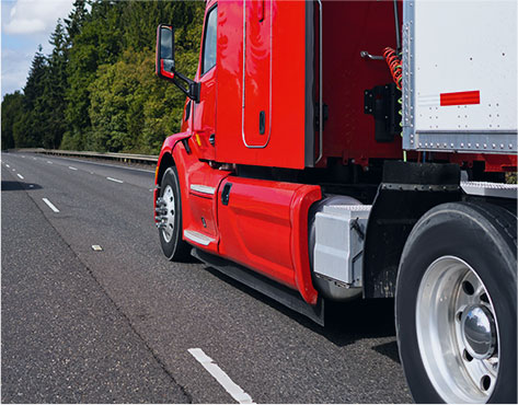 Red tractor trailer carrying LTL shipment across the USA
